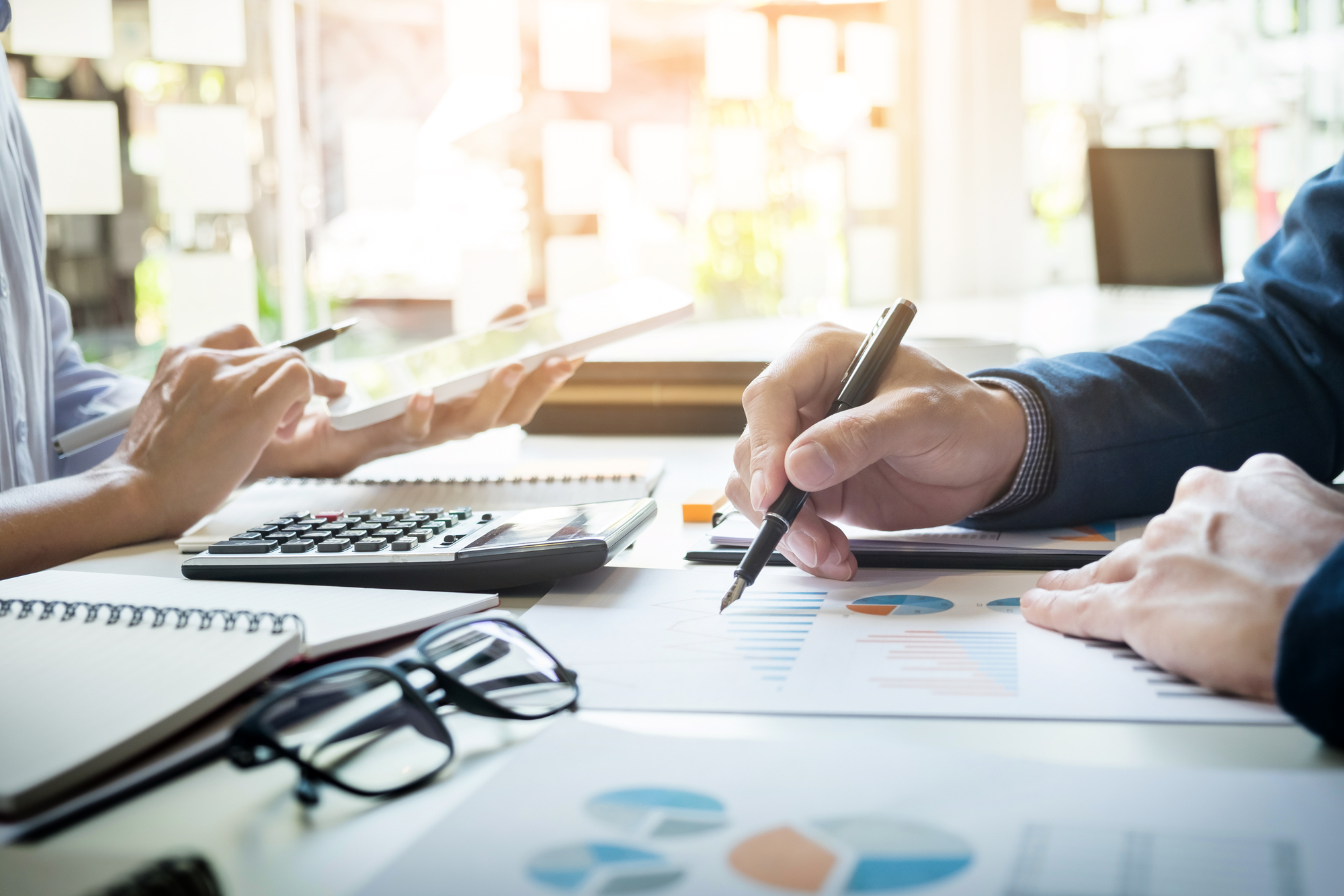 Administrator business man financial inspector and secretary making report, calculating or checking balance.